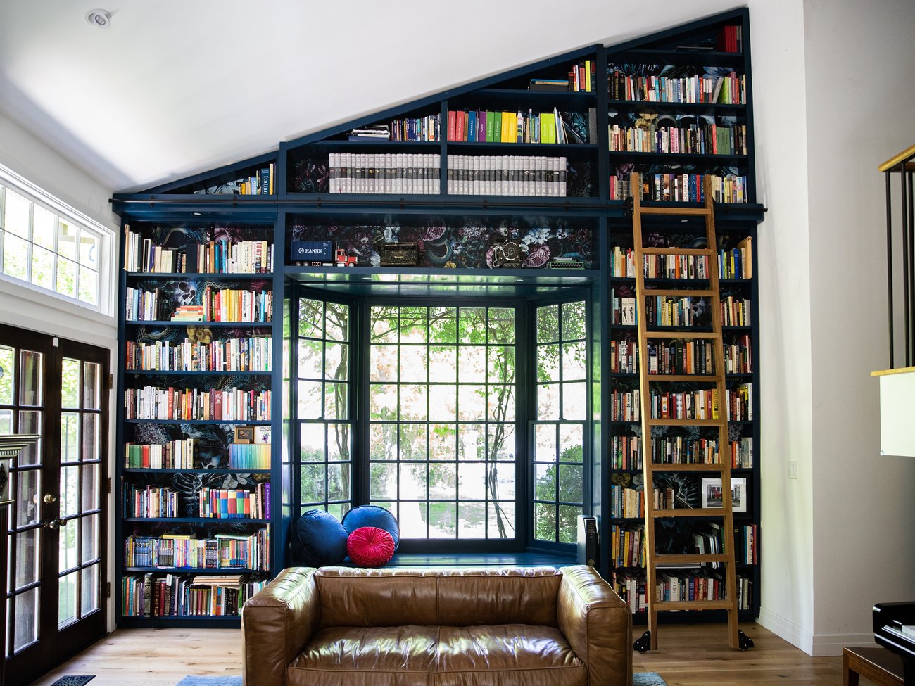 Custom floor-to-ceiling library bookcase by Girl Flip Construction