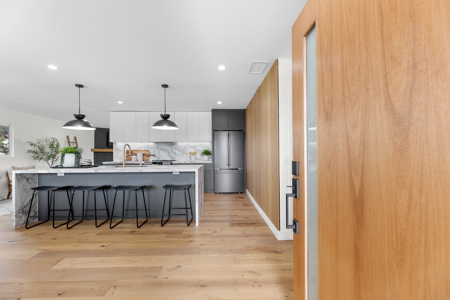 Marble waterfall island kitchen in Torrance